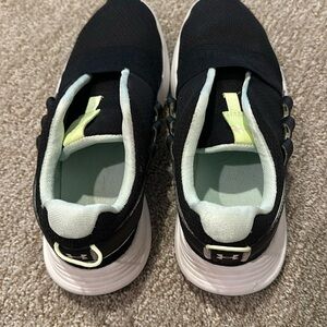 Under Armour gym shoes with mint green detailing.